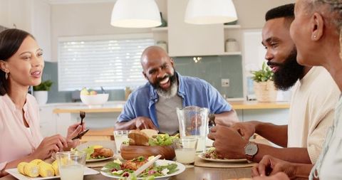 Multigenerational Family Enjoying Mealtime Together in Modern Kitchen