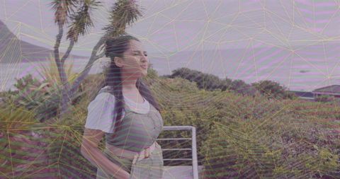 Serene coastal reflection on balcony amid lush greenery