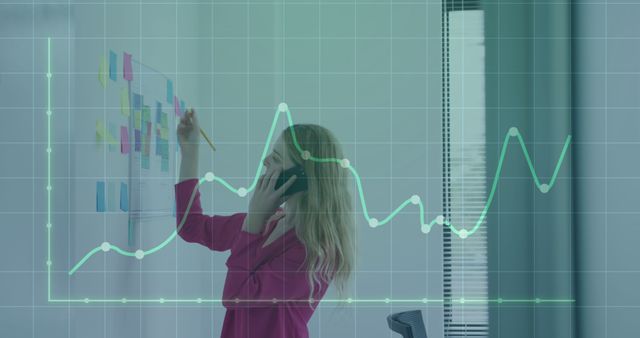 Businesswoman Analyzing Data with Graph Overlay in Office Environment - Download Free Stock Images Pikwizard.com