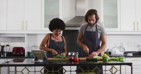Couple Chopping Vegetables Together in Modern Kitchen