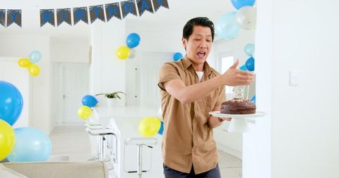Father Celebrating at Home with Cake Birthday Decorations