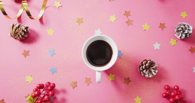 Image of coffee, red berries, stars and pine cones on pink background. christmas, tradition and celebration concept.