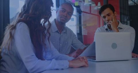 Discussing Strategy in Glass Boardroom, Team Collaborating Around Laptop and Documents