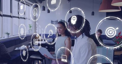 Coworking Collaboration Showing Augmented Reality Icons in Modern Open-Plan Workspace