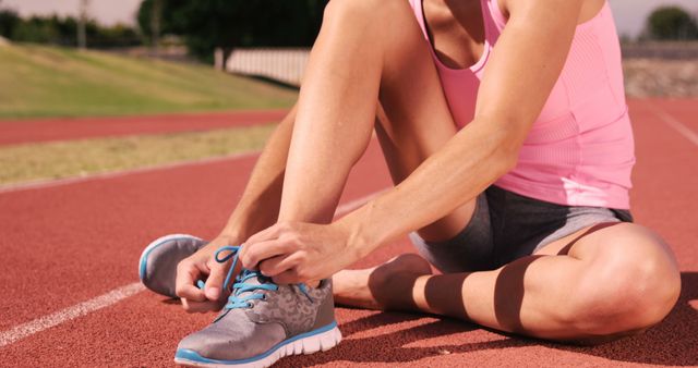 Woman Tying Running Shoes on Outdoor Track - Download Free Stock Images Pikwizard.com