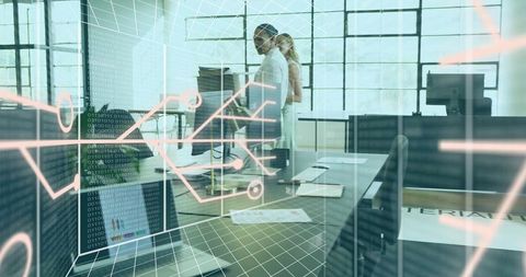 Colleagues reviewing code with augmented reality overlay in industrial open office workspace