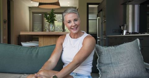 Smiling Senior Woman Relaxing in Modern Open-Plan Living Room