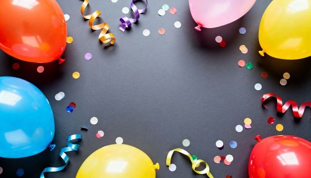 Colorful balloons and confetti framing dark center for party banner and invitation design