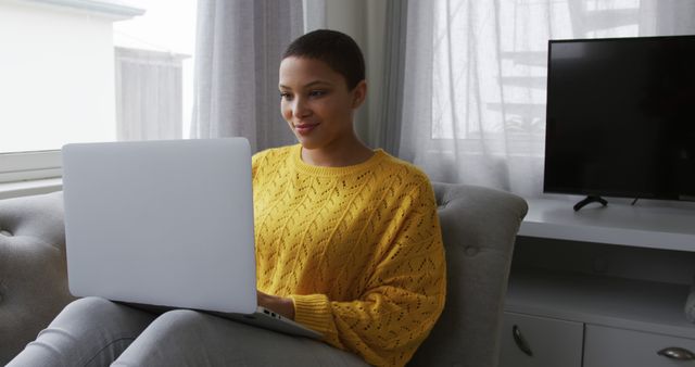 Woman Sitting on Sofa Using Laptop in Bright Living Room - Download Free Stock Images Pikwizard.com