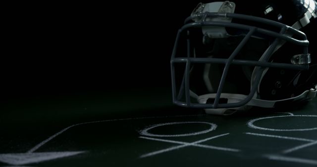 Football Helmet with Playbook Diagram Under Low Light - Download Free Stock Photos Pikwizard.com