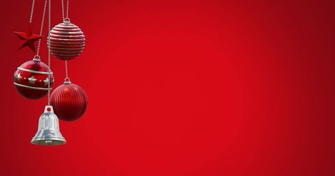Hanging Christmas Baubles and Bell Against Festive Red Background - Download Free Stock Images Pikwizard.com