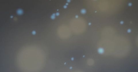 Soft blue and beige bokeh glow on neutral gray field for ambient abstract texture