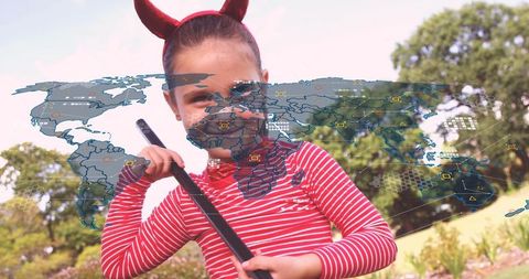 Child wearing devil horns and red-striped shirt holding stick with holographic world map