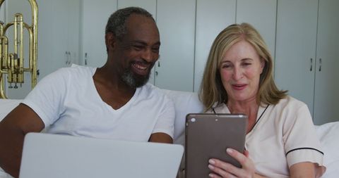 Diverse Senior Couple Enjoying Technology at Home