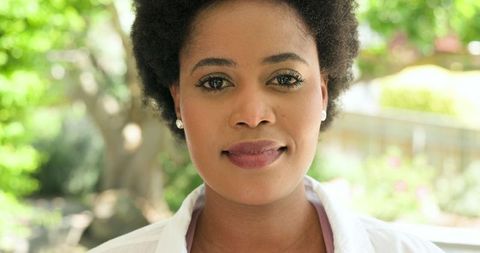 Smiling African American Woman in Sunlit Garden