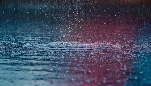 Rain Droplets Creating Concentric Ripples in Vibrant Colors