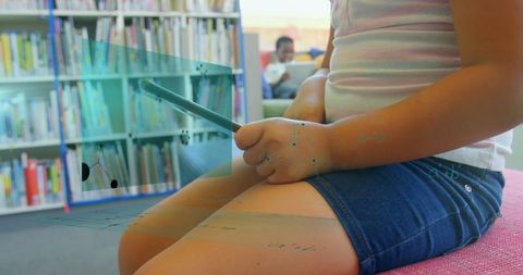 Child immersed in learning at vibrant school library