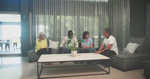 Diverse Seniors Engaging in Friendly Conversation at Home