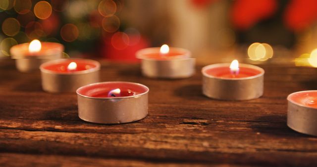 Tealight candles burning on wooden table 4k