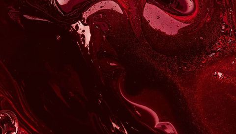 Deep red liquid marble texture with glossy swirls and metallic speckles
