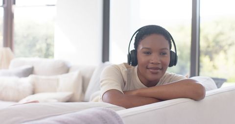 Relaxed Young Woman Listening to Music with Headphones at Home - Download Free Stock Images Pikwizard.com