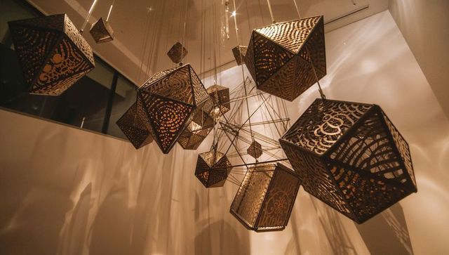Artistic metal lantern installation casting ambient light pattern