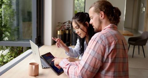 Young Couple Collaborating on Travel Plans at Home - Download Free Stock Images Pikwizard.com