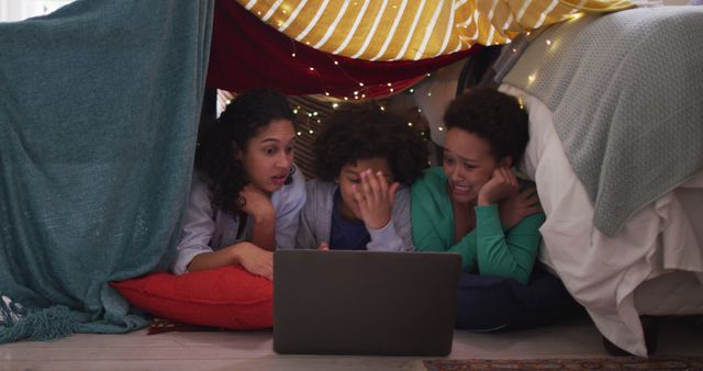 Three Friends Watching Movies in Cozy Blanket Fort with Laptop - Download Free Stock Images Pikwizard.com