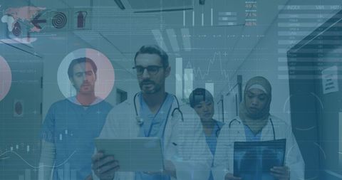 Healthcare professionals analyzing digital data in hospital corridor