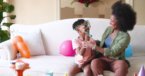 Family Birthday Celebration with Candles and Laughter at Home