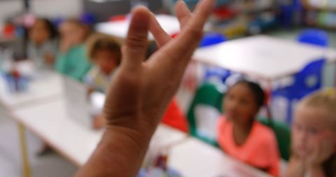 Teacher's Hand Gesturing While Engaging Classroom of Young Students