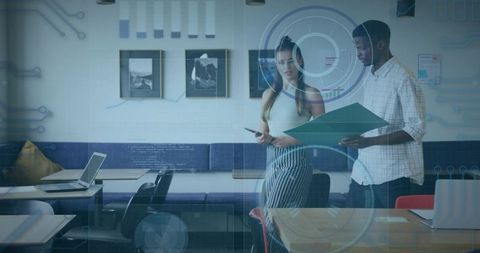 Young professionals collaborating with holographic interface in modern office lounge