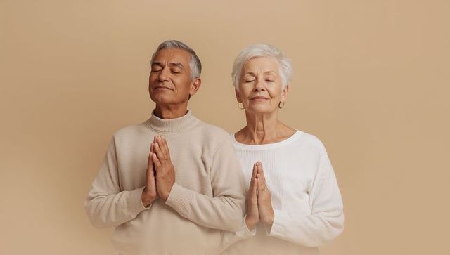 Senior couple practicing meditation with palms pressed, calm mindfulness and peace portrait