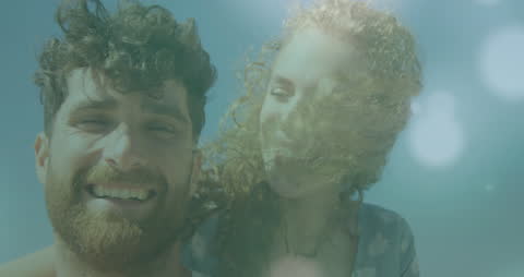 Couple Enjoying Beach with Sunlit Smiles and Ocean View