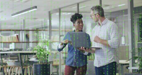 Colleagues collaborating in modern office with binary code overlay