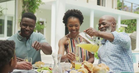 Joyful African American Family Enjoying Outdoor Breakfast