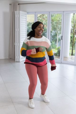 Active woman enjoying home workout in bright indoor space