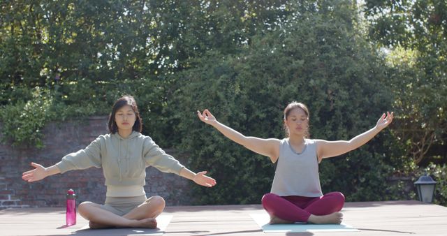 Two Women Meditating Outdoors in Quiet Garden - Download Free Stock Images Pikwizard.com