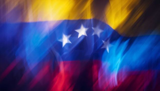 Venezuelan tricolor waving with motion blur and painterly light streaks abstract