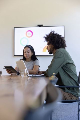 Diverse Business Team Collaborating with Digital Devices and Charts