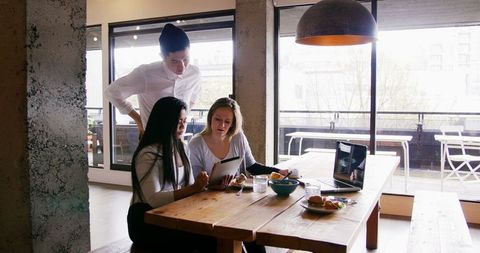 Team collaboration during lunch break in modern office
