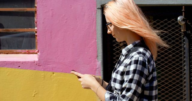 Woman with Pink Hair Using Smartphone Near Colorful Wall - Download Free Stock Images Pikwizard.com