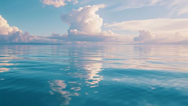 Calm turquoise ocean with pastel clouds reflecting bliss