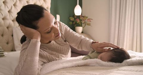 Mother Bonding with Baby in Cozy Bedroom Environment