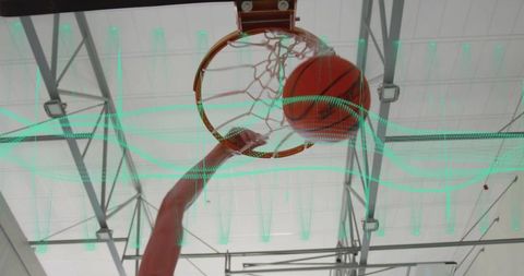 Athlete Scores Basket with Intense Action