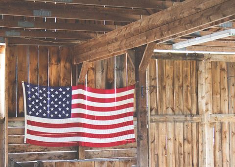 American Flag Hanging in Rustic Wooden Barn Interior