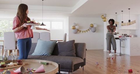 Friends Cleaning Up After Birthday Celebration at Home