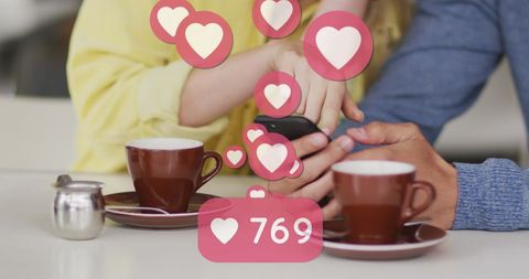 Caucasian Couple Enjoying Coffee While Using Smartphone