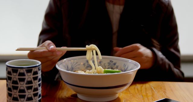 Person Enjoying Delicious Bowl of Fresh Udon Noodles - Download Free Stock Images Pikwizard.com