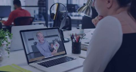 Professional Woman Engaged in Online Meeting Working at Modern Office